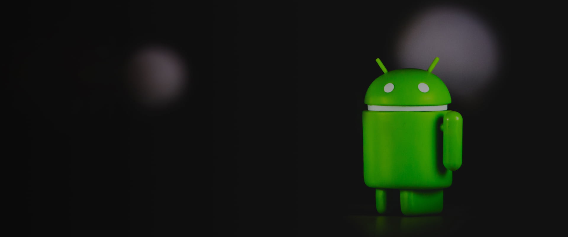 Green android robot on the dark background