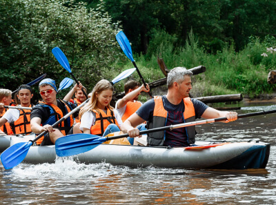 The company team sail down on canoes