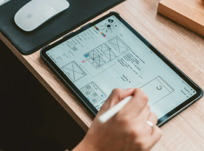 A person drawing schemes on a tablet