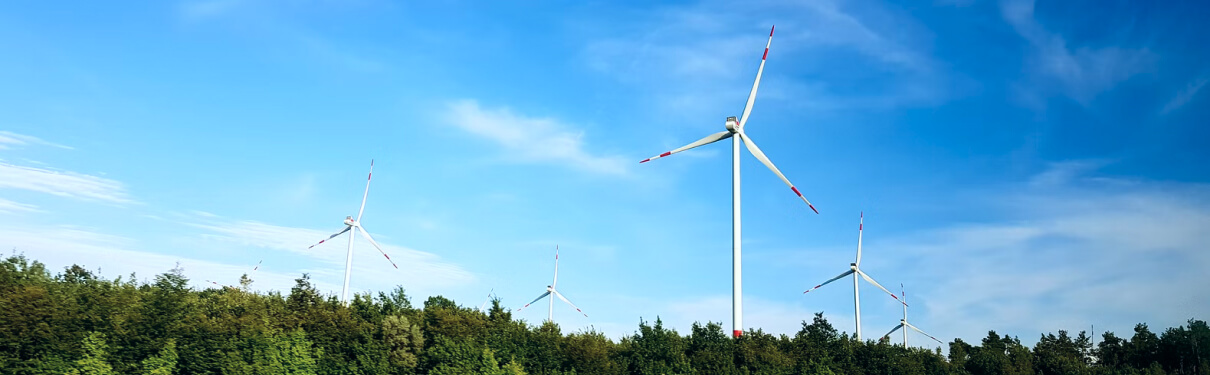 A wind farm in the forest and sky background