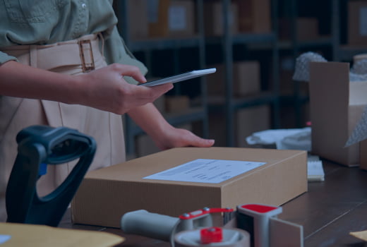 A person examining parcel delivery information using a phone