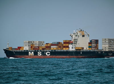 A cargo ship transports containers by sea