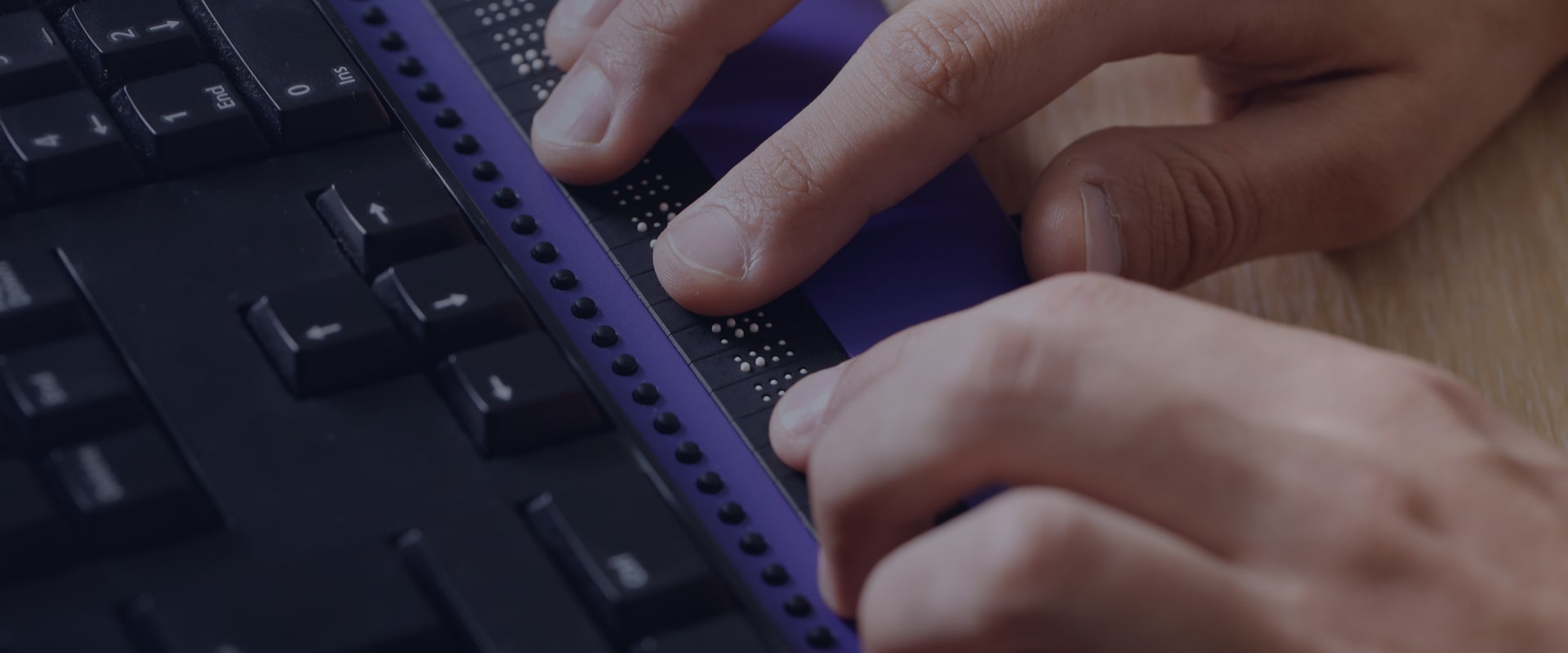 A person using a low-vision keyboard