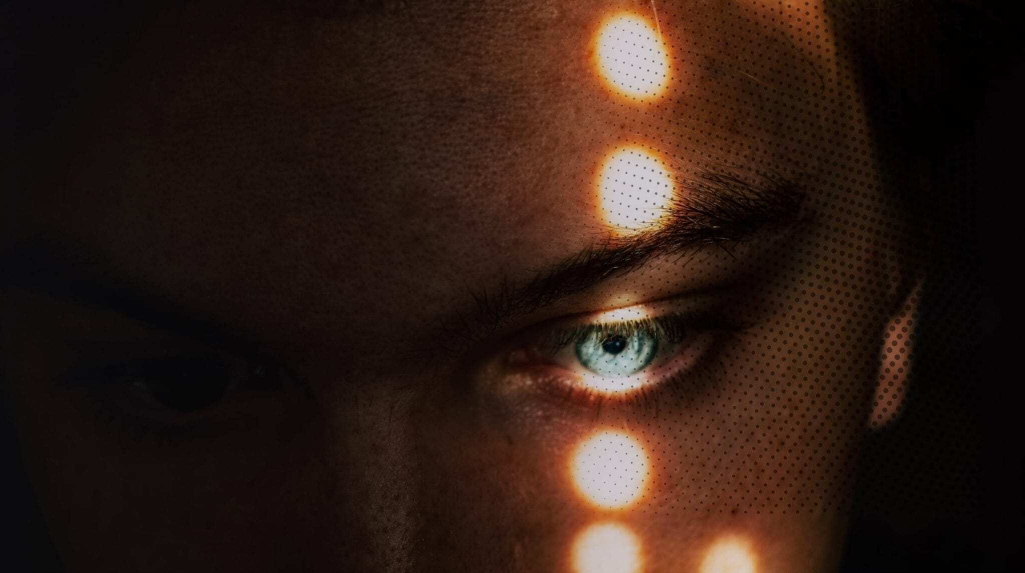A human eye and several light points on the face