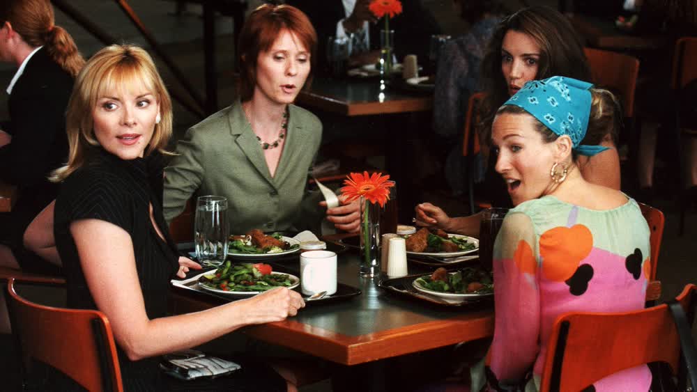 Four characters of the popular series sitting at the table