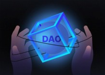 Two hands holding a cube with a circle and DAO inside it